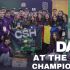 Group of students and mentors pose with a green robot and a 'CSH' banner at a robotics championship; Day 3 at the First Championship text visible.