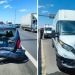 Two vehicles damaged in a highway collision: a crushed small car on the left with responders nearby; a dented white van on the right with an ambulance behind.