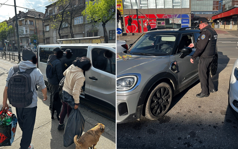People boarding a white van with bags on the sidewalk; a small dog nearby, outdoors on a city street at a checkpoint or border area.