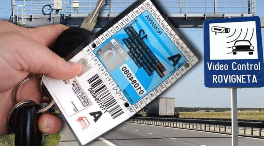 Close-up of a hand holding car keys and a blue ticket/permit, with a highway and a 'Video Control' surveillance sign in the background.