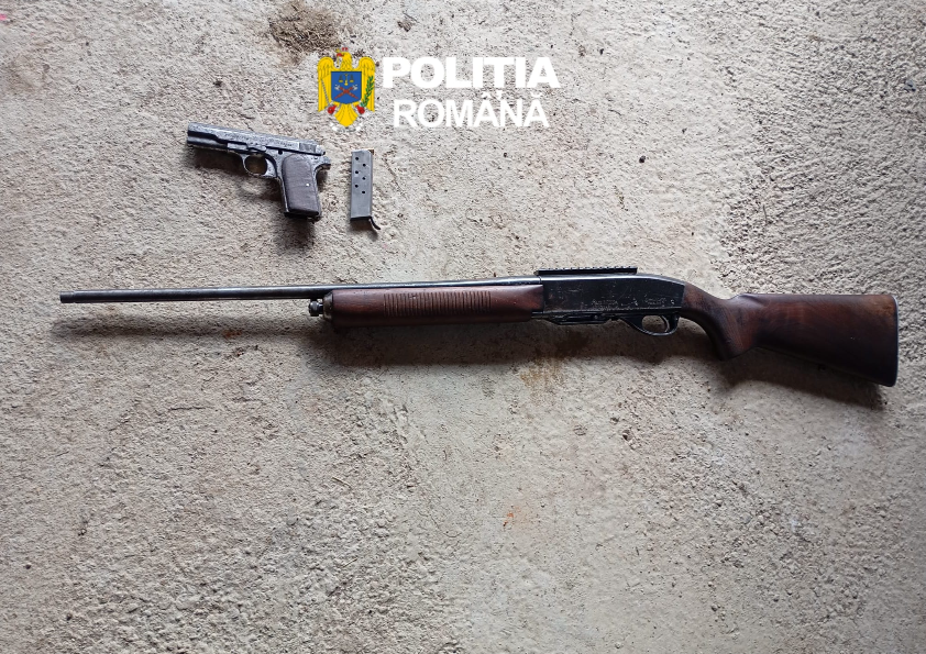 Romanian Police emblem with a pistol, two magazines, and a long rifle laid on a rough concrete surface.