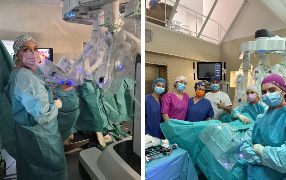 Medical team in surgical gowns and masks around a robotic-assisted operation, with robotic arms overhead in the OR