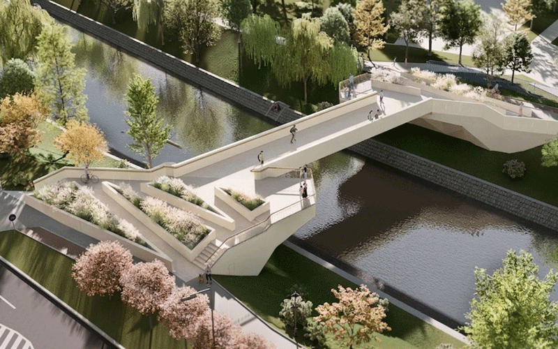 Aerial view of a modern white pedestrian bridge with stepped terraces spanning a canal, with people walking and trees around.