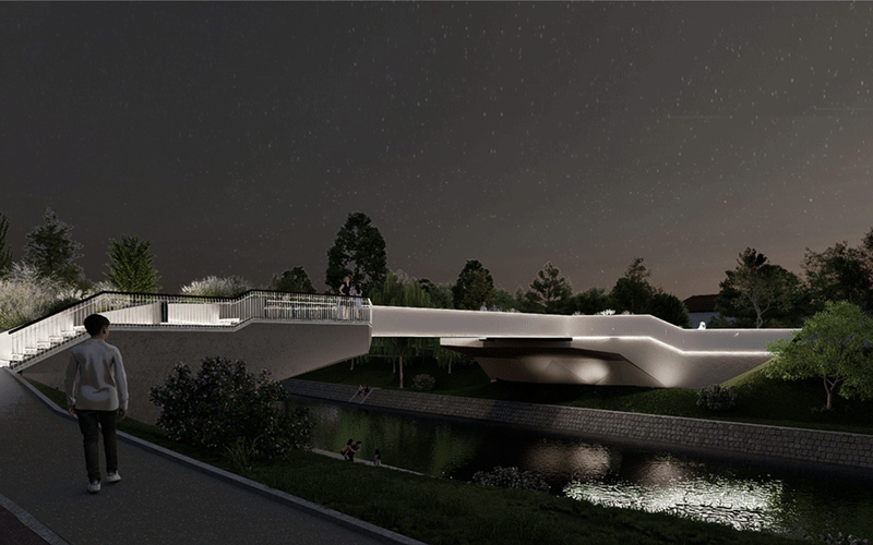 pasarela-indragostitilor5 - Sursa de Vest Night view of a modern illuminated pedestrian bridge over a canal, with a person walking along a path.