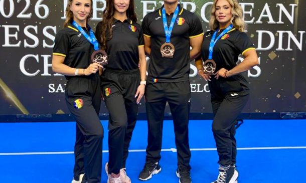 Four athletes in black uniforms with Romania badges pose on a blue stage, each wearing a bronze medal and smiling for a trophy photo.