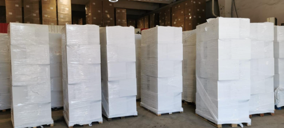 Stacks of white-wrapped pallets in a spacious warehouse with the Poliția Română logo overhead