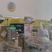 NICU room with several infant incubators and medical monitors mounted on a yellow wall panel.