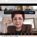 Video conference screenshot: main speaker Florica Chirita wearing glasses and a brown blazer, with participant thumbnails along the top edge.