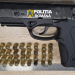 Black semi-automatic pistol with Romanian Police branding, placed on a wooden surface, with multiple brass cartridges arranged in rows below and a metal ruler for scale.